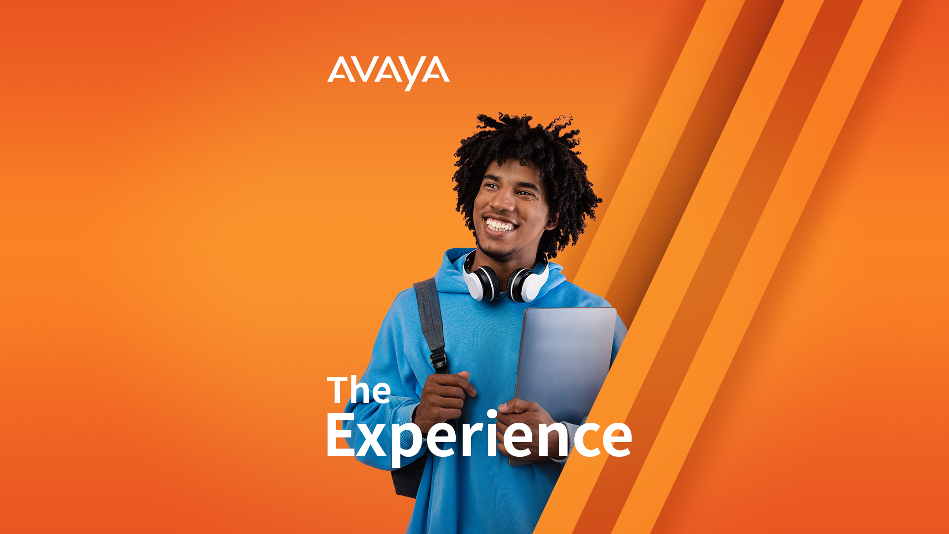 College student holding backpack and laptop with headphones around his neck