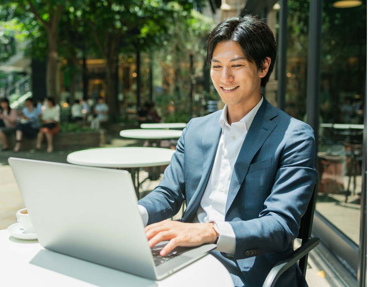 Young Asian businessman typing on a laptop