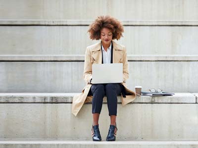 Woman seated on steps reading ...
