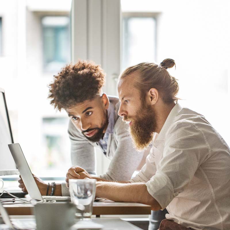 Two male web developers looking at a computer screen