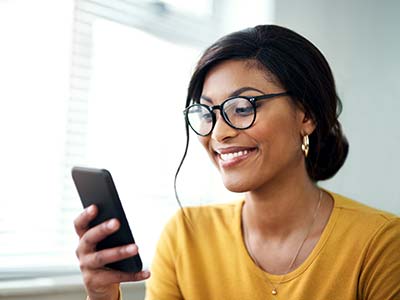 Smiling woman looking at her phone 