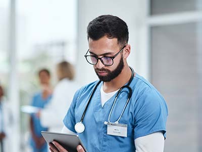 Medical practitioner using a digital tablet in a hospital