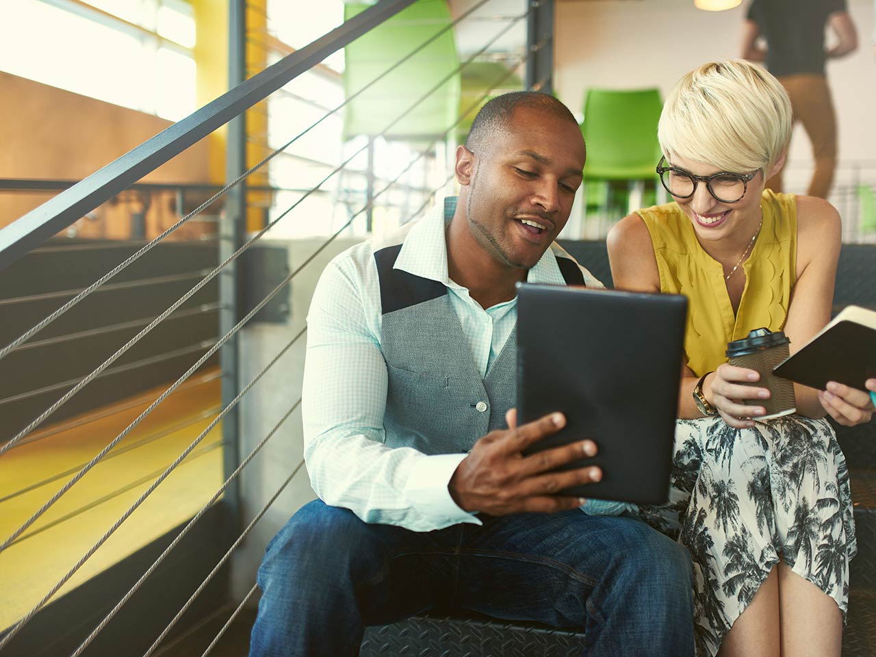 Coworkers looking at a tablet.