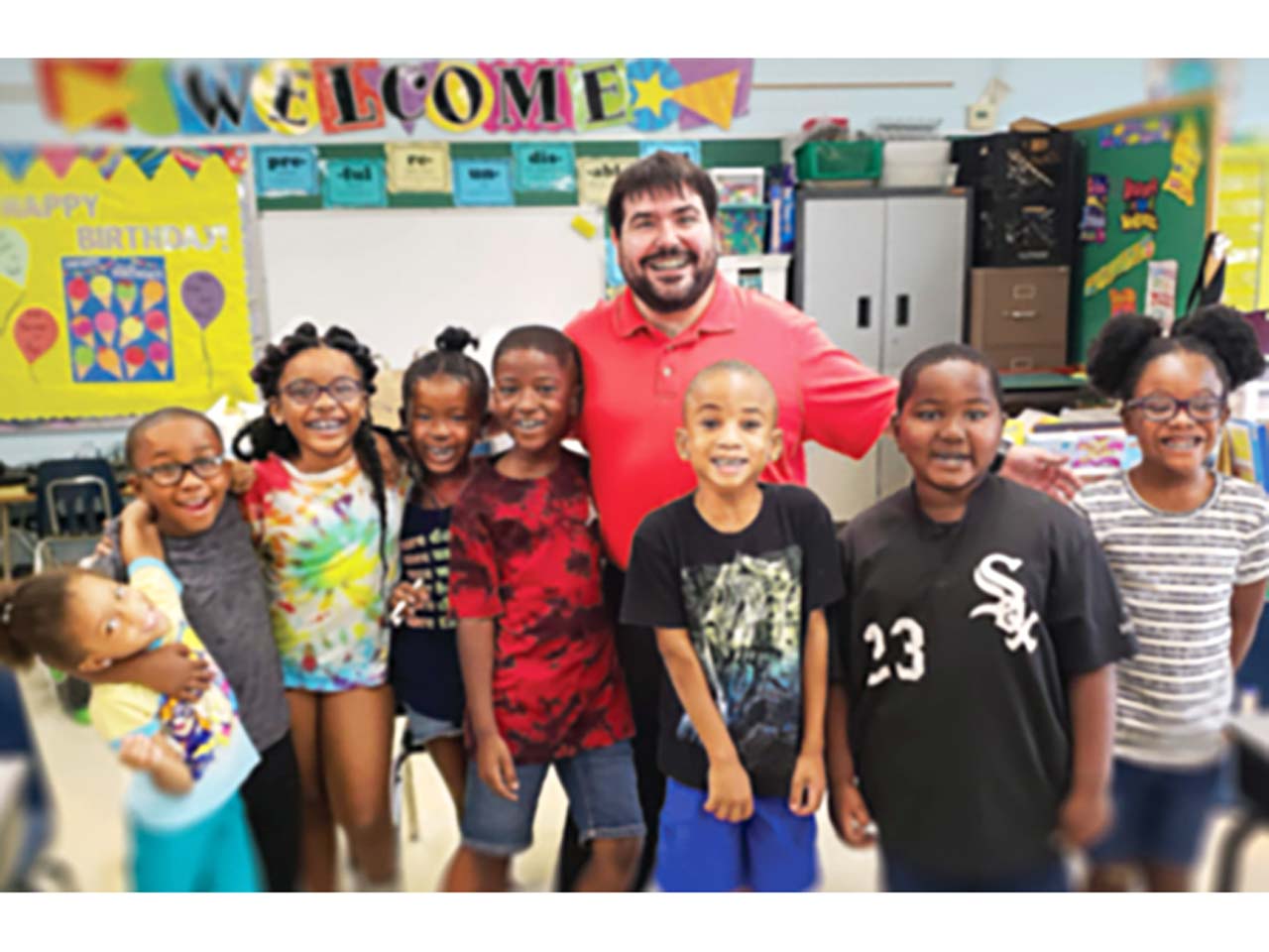 Group photo of kids and teacher