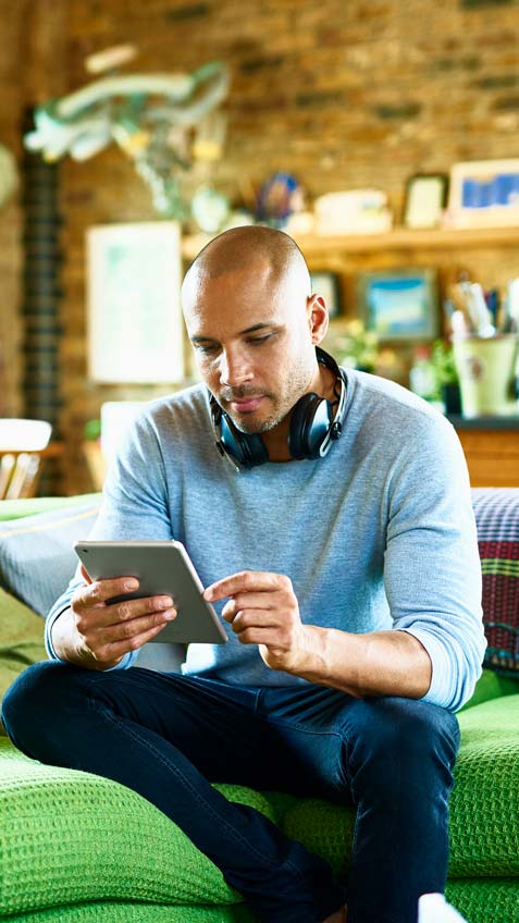 Man with headphones looking at tablet