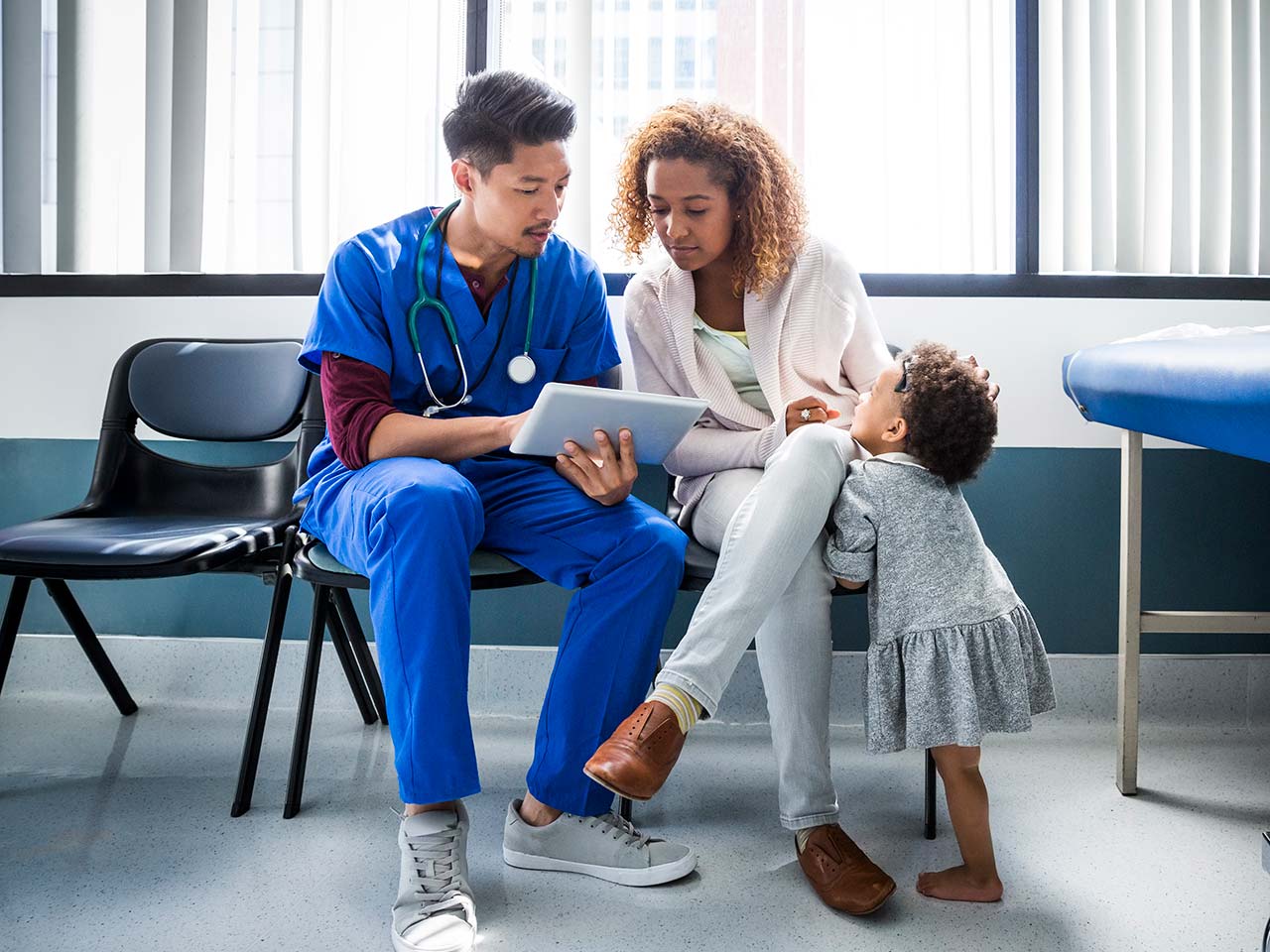 Doctor advising patient on his iPad