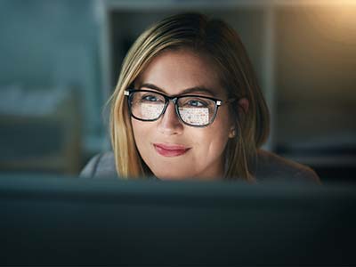 Businesswoman working late on a computer in an office