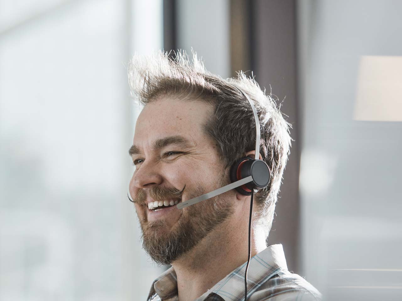 Man on headset smiling