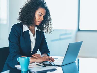 Woman in suit looking at her computer
