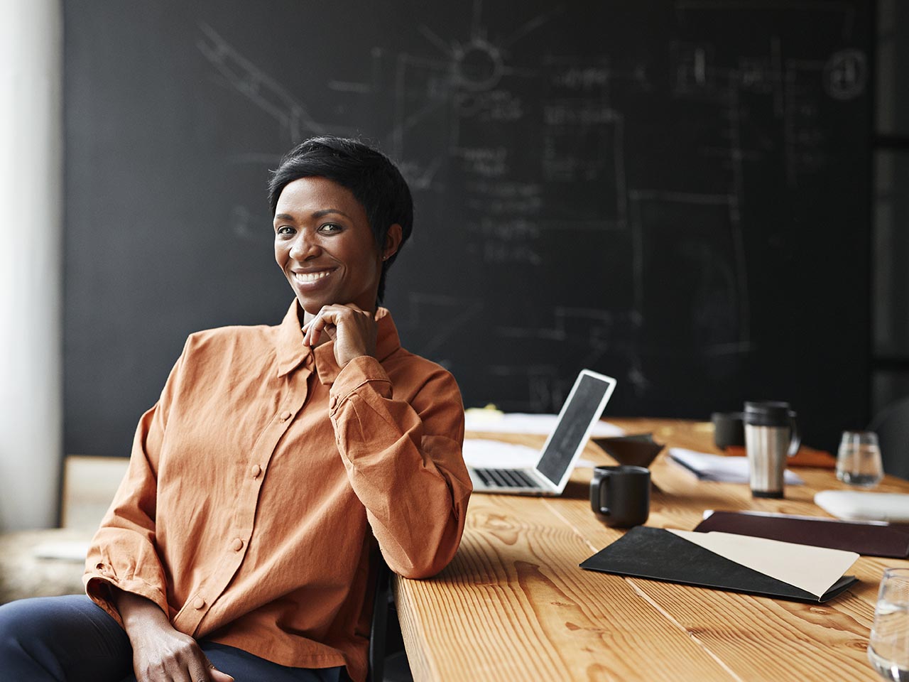 Woman smiling and working on a computer