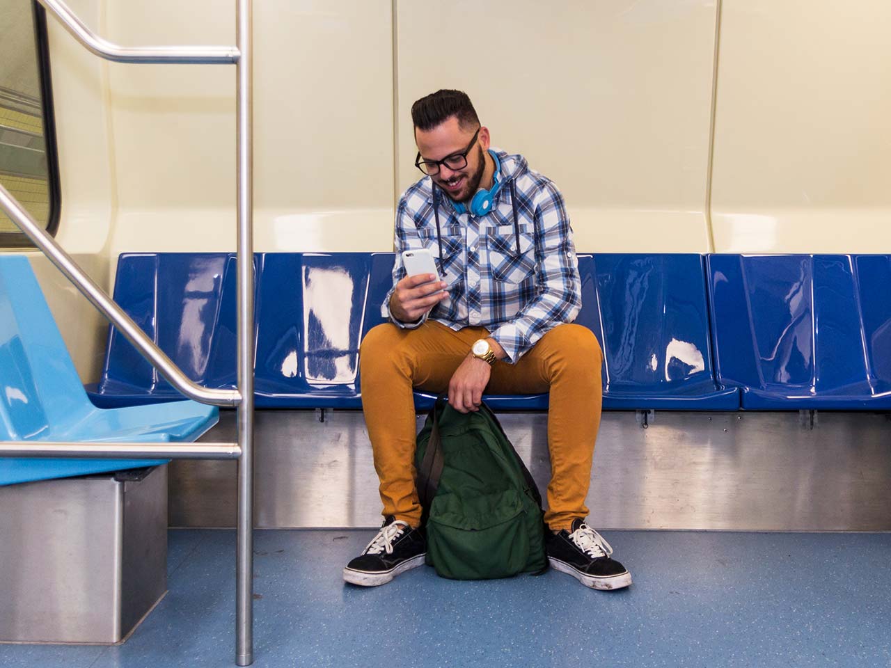 Woman wearing a mask, riding on metro, reading a text message