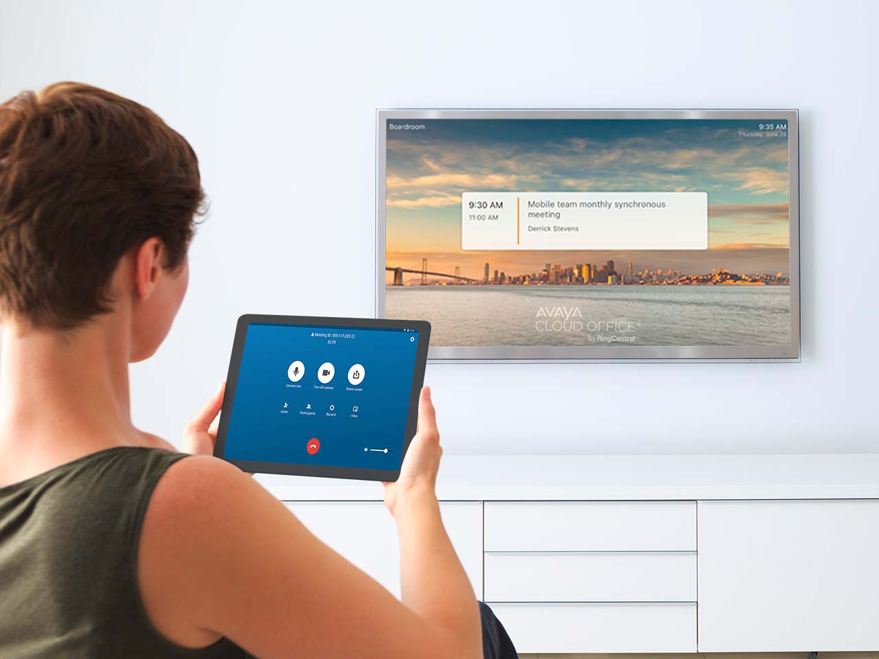 Woman using a tablet in her living room with a tv in background