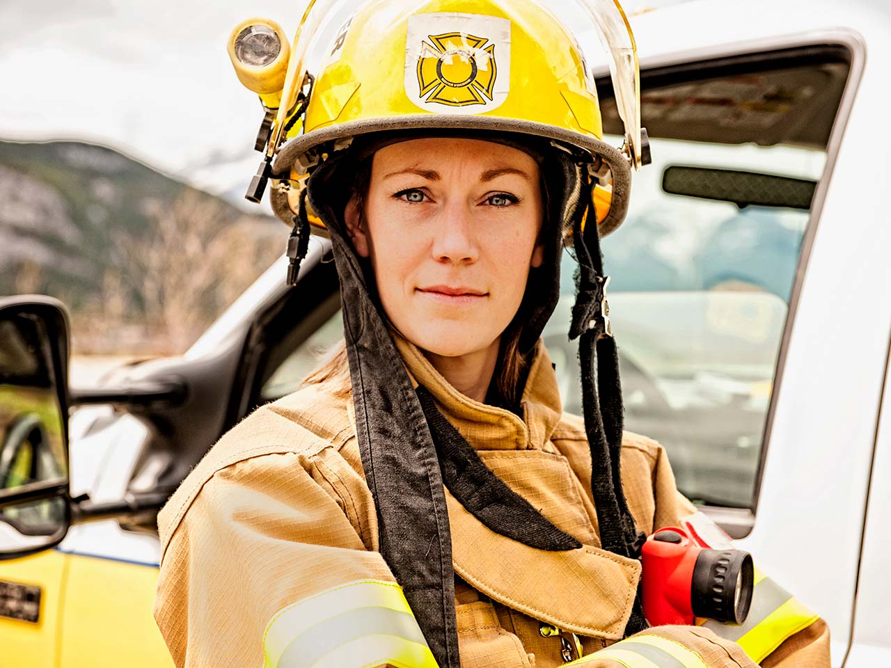 First responder standing next to a truck.