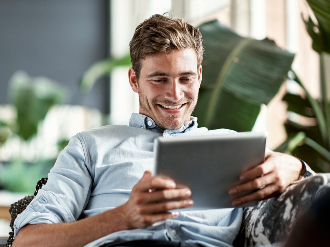 Man smiling looking at an iPad