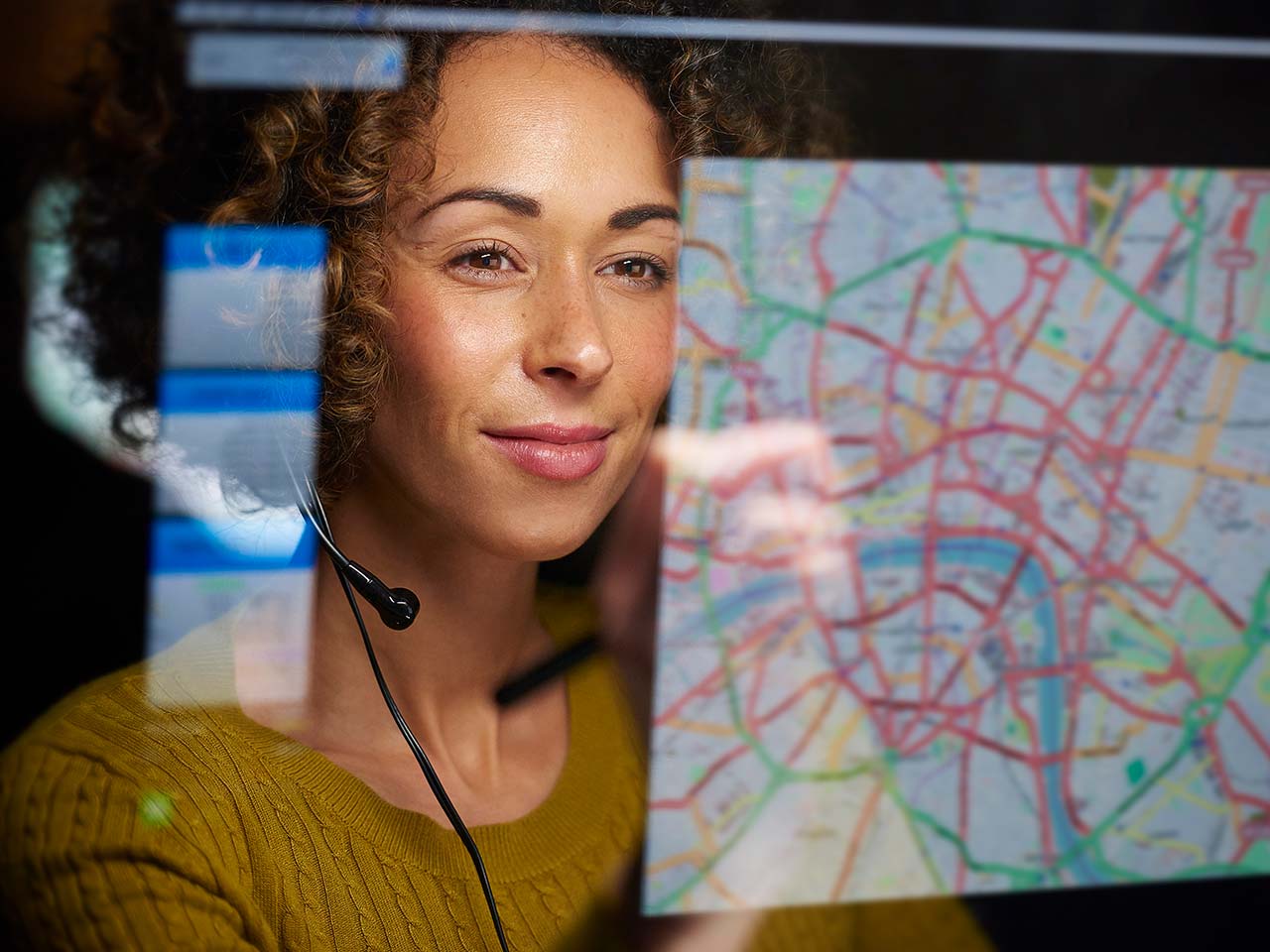 Dispatcher looking at computer screen with map