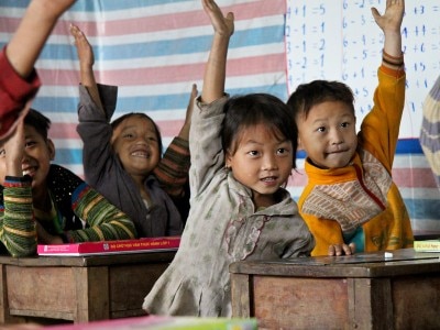 School children in Vietnam raising their hands