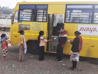 Children lined up at a school on wheels bus in India 